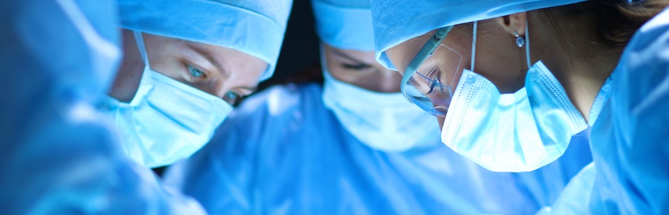 group of surgeons operating