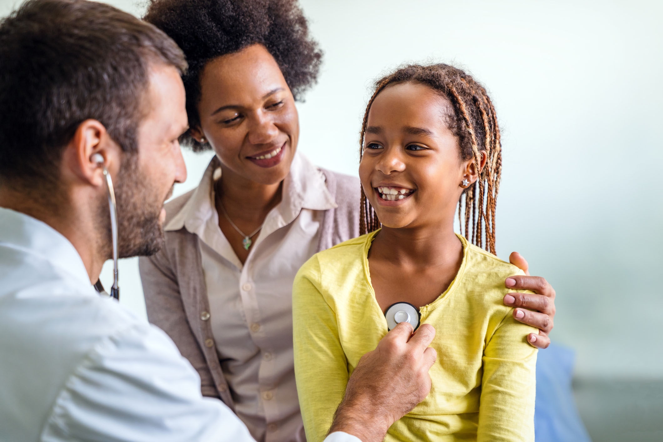 Older female child smiles during a doctor's appointment