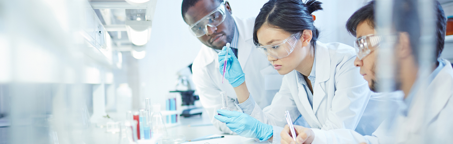 Researchers crowded around a table in a lab