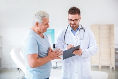older man meets with doctor