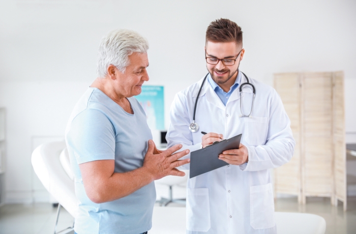 older man meets with doctor