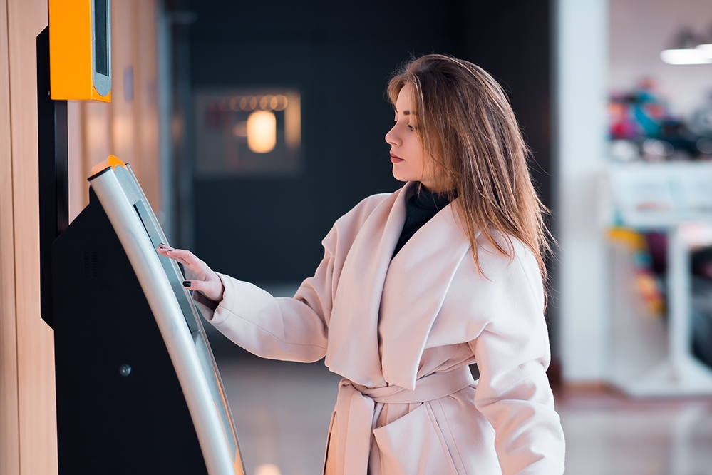 Woman using a kiosk